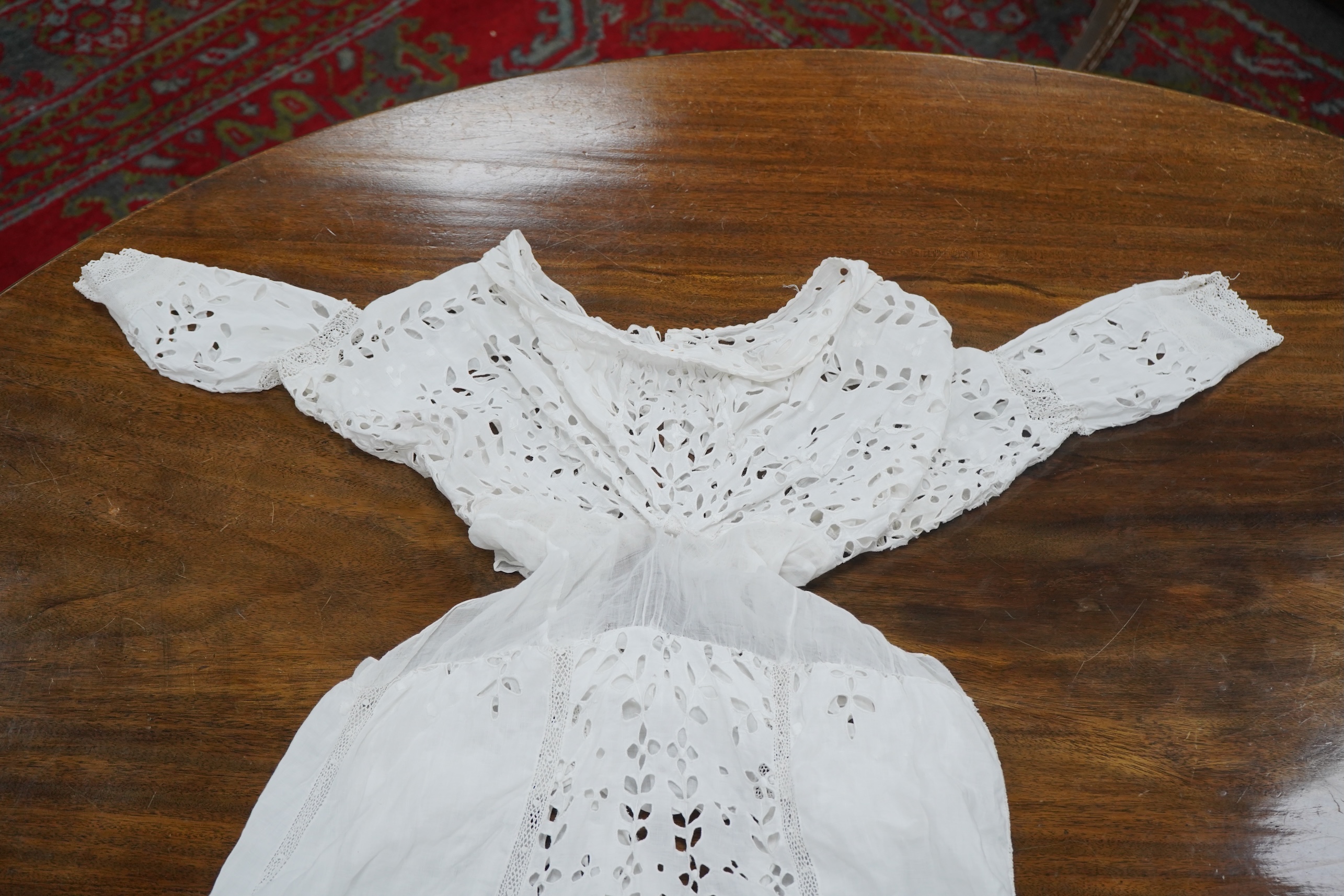 An Edwardian fine white embroidery anglaise and Irish crochet trimmed ladies summer dress, designed with large panels of anglaise cut work, the dress has been altered and restyled, which could be altered back, 134cm long